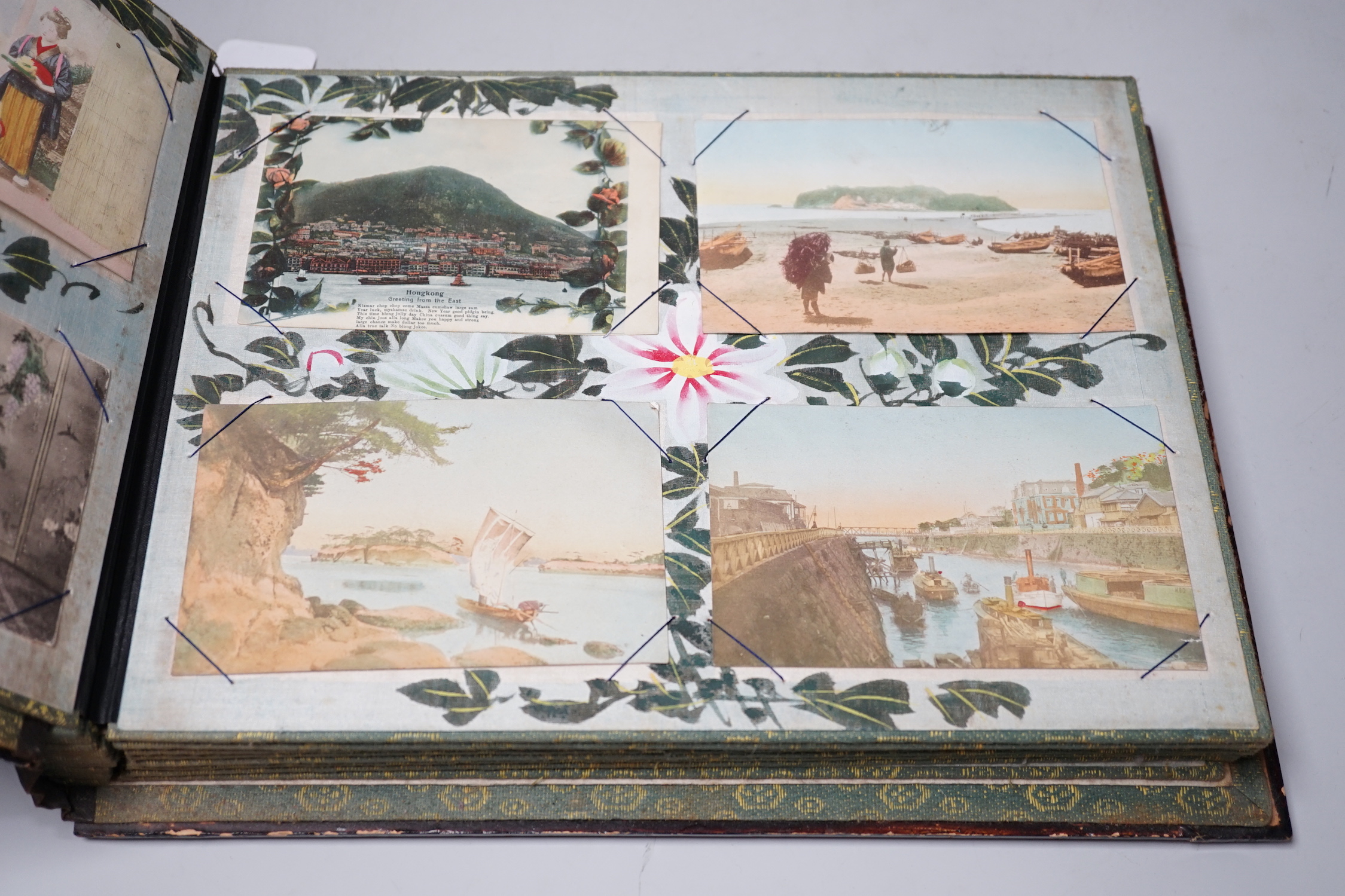 A Japanese photo album with handcoloured postcards of Japan, Ceylon, India etc.